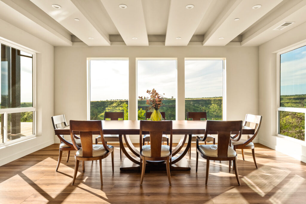 Dining room in modern home with panoramic windows and scenic California views.