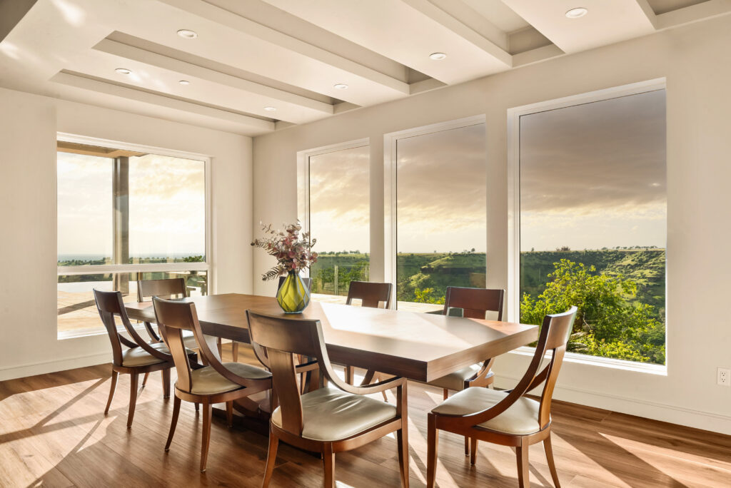 Contemporary dining area with large windows and wood furniture in Butte County home