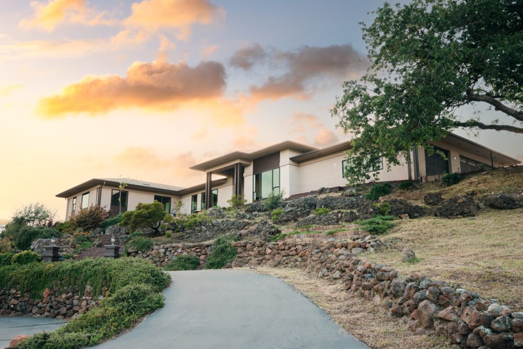 Side view of a modern Butte County home with large glass windows and sloped roofline