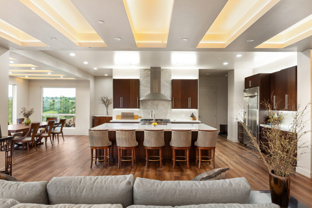 Modern kitchen with marble island and dining area overlooking scenic views